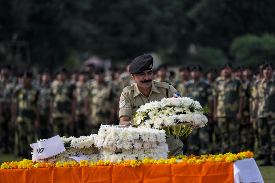 Indian Border Security Force (BSF) soldiers pay tribute to their colleague Lal Fam Kima during a wreath-laying ceremony at the BSF headquarters in Jammu, India, Thursday, Nov.9, 2023. The BSF soldier was killed as Indian and Pakistani soldiers exchanged gunfire and shelling along their highly militarized frontier in disputed Kashmir. (AP Photo/Channi Anand)