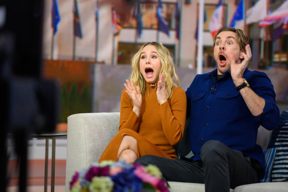 The couple sitting on a couch during an interview with astounded looks on their face