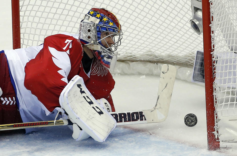 Russia goaltender Sergei Bobrovski watches the puck bounce back off the net after a goal by the USA in the second period of a men's ice hockey game at the 2014 Winter Olympics, Saturday, Feb. 15, 2014, in Sochi, Russia. (AP Photo/Petr David Josek)