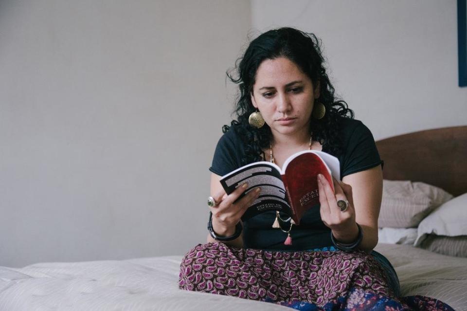 L&eacute;nica Morales, Enrique's romantic partner, reads the book he wrote from prison.&nbsp;