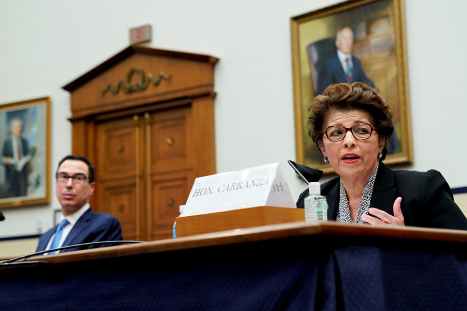 Jovita Carranza, administrator of the U.S. Small Business Administration (SBA), speaks as Steven Mnuchin, U.S. Treasury Secretary, left, listens during a House Small Business Committee hearing in Washington, DC, U.S., July 17, 2020. The committee hearing is looking into the Small Business Administration and Treasury pandemic programs. Erin Scott/Pool via REUTERS