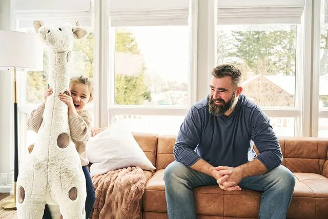 <p>courtesy of Pottery Barn Kids</p> Jason Kelce shares a laugh with daughter Wyatt as she hugs a giant stuffed giraffe's neck