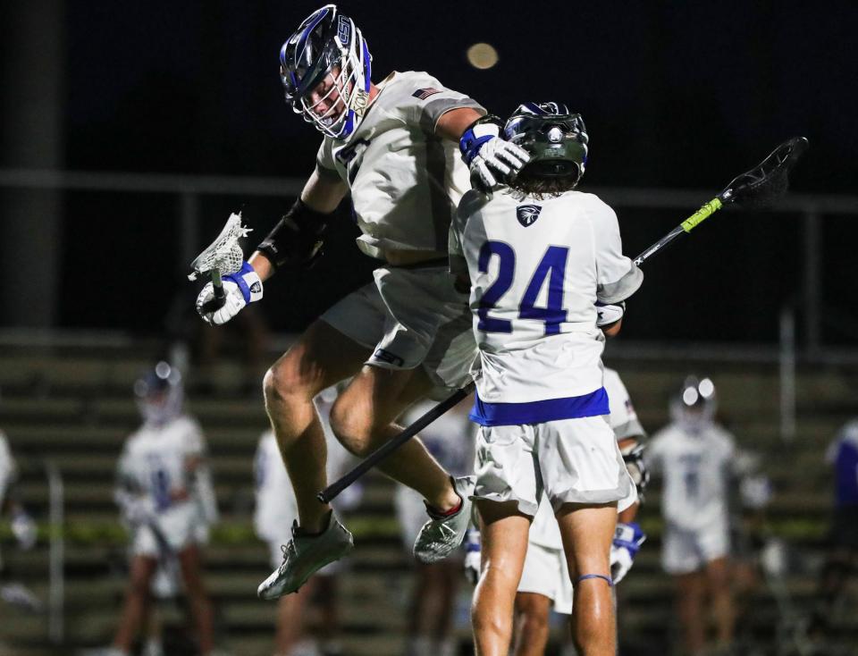 Community School of Naples Seahawks attacker Ramsey Huggins (3) celebrates a goal with midfielder Charlie Youngs (24) during the second quarter of the Class 1A Region 3 semifinal against the Cardinal Mooney Cougars at Community School of Naples on Wednesday, April 26, 2023.