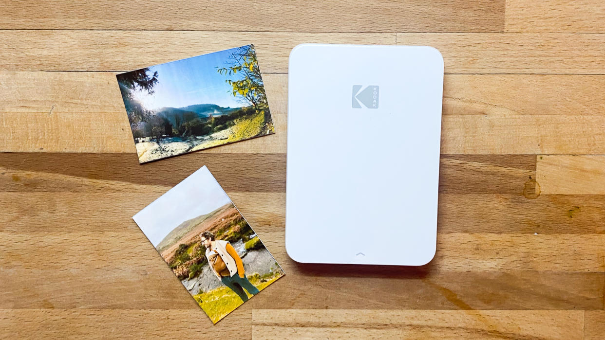  A Kodak Step Slim printer on a wooden desk. 