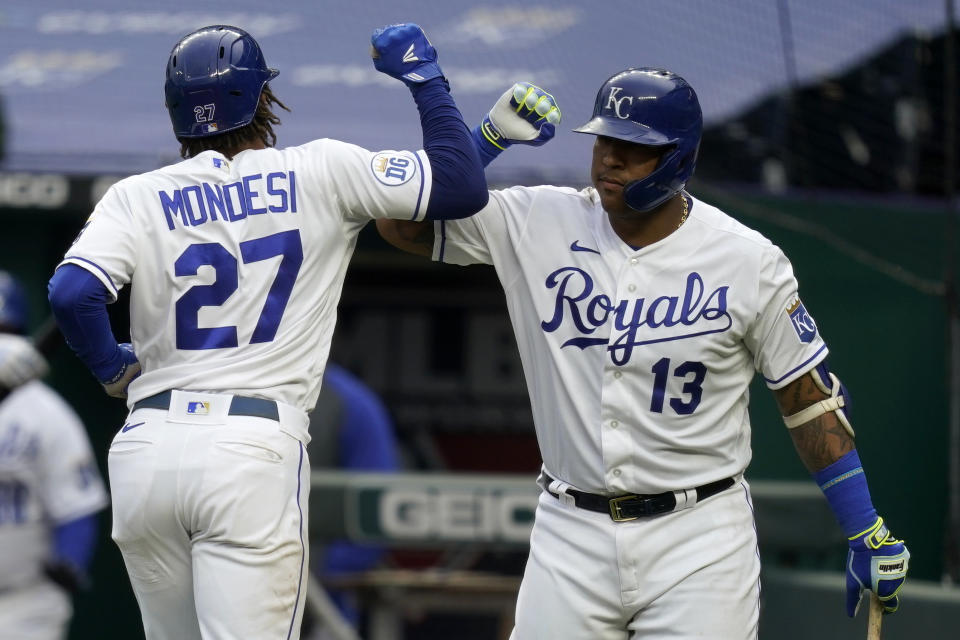 Kansas City Royals Adalberto Mondesi (27) is congratulated by teammate Salvador Perez (13) after his solo home run during the fourth inning of a baseball game against the Detroit Tigers at Kauffman Stadium in Kansas City, Mo., Sunday, Sept. 27, 2020. (AP Photo/Orlin Wagner)