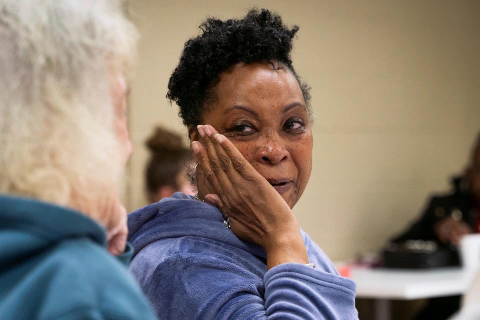 Tonya Hogan looks toward shelter resident Debbie Berkley-Joseph, while wiping away tears during a weekly women's Bible study class at Harbor Light Salvation Army in Detroit on Thursday, March 9, 2023.