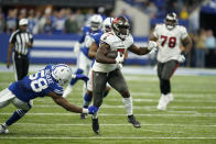 Tampa Bay Buccaneers' Leonard Fournette (7) runs past Indianapolis Colts' Bobby Okereke (58) during the second half of an NFL football game, Sunday, Nov. 28, 2021, in Indianapolis. (AP Photo/Michael Conroy)