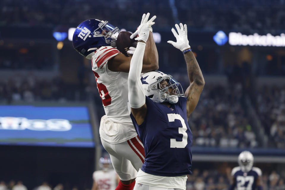 New York Giants wide receiver Darius Slayton, left, catches a pass for a first down as Dallas Cowboys cornerback Anthony Brown (3) defends during the first half of an NFL football game Thursday, Nov. 24, 2022, in Arlington, Texas. (AP Photo/Michael Ainsworth)