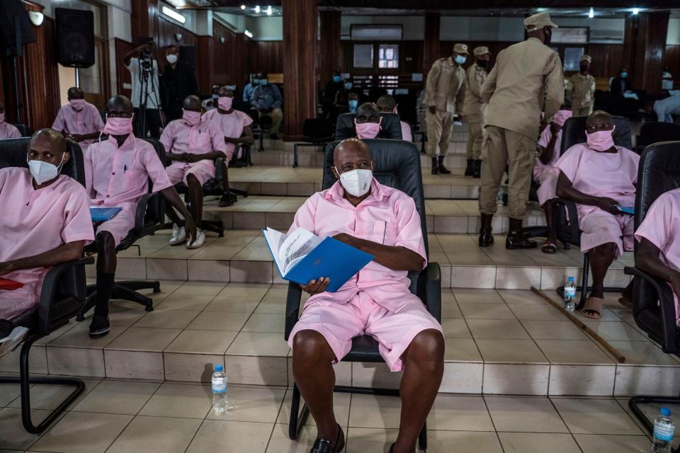 Rusesabagina and fellow accused sitting in matching pink uniforms in courthouse