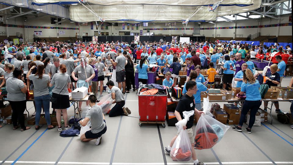 Nearly 800 volunteers work to fill 40,000 backpacks with school supplies. - Jonathan Wiggs/The Boston Globe/Getty Images/FILE