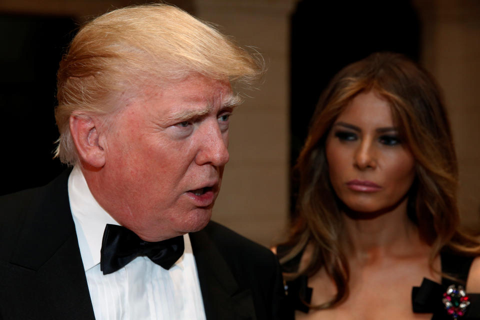 President-elect Donald Trump talks to reporters as he and his wife, Melania Trump, arrive for a New Year's Eve celebration with members and guests at the Mar-a-Lago Club in Palm Beach, Florida, on Dec. 31, 2016.