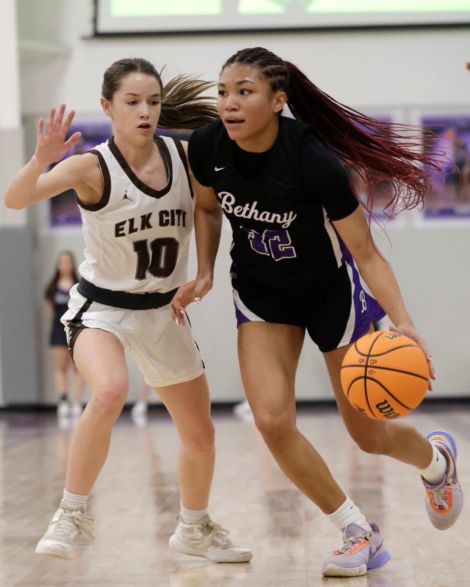 Bethany's Keziah Lofton (32) goes against Elk City's Luci O'Hara (10) during a high school basketball game Thursday, Feb. 22, 2024, at Bethany High School.