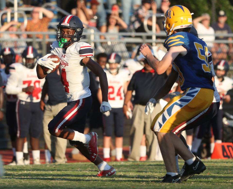 First State Military Academy's De'Jere Johnson (left) takes off on a gain in the Bulldogs' 55-0 win at A.I. du Pont High School, Friday, Sept. 1, 2023.