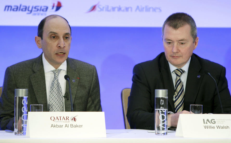 CEO of Qatar Airways Akbar Al Baker, left, speaks during a news conference while International Airlines Group chief executive Willie Walsh looks on in New York, Monday, Oct. 8, 2012. Qatar Airways is joining an alliance of airlines including American Airlines, British Airways and nine other carriers that coordinate routes and allow passengers to earn frequent flier miles on each other's flights. (AP Photo/Seth Wenig)