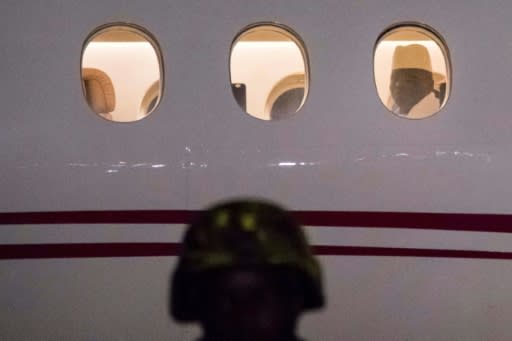 Out: Jammeh looks through a plane window as he leaves The Gambia on 21 January 2017