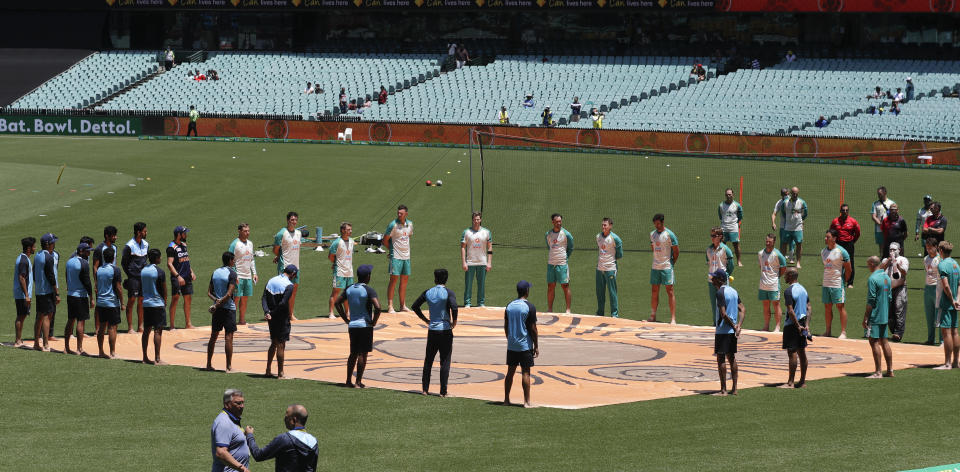 Players stand for a ceremony on the field ahead of the one day international cricket match between India and Australia at the Sydney Cricket Ground in Sydney, Australia, Friday, Nov. 27, 2020. (AP Photo/Rick Rycroft)