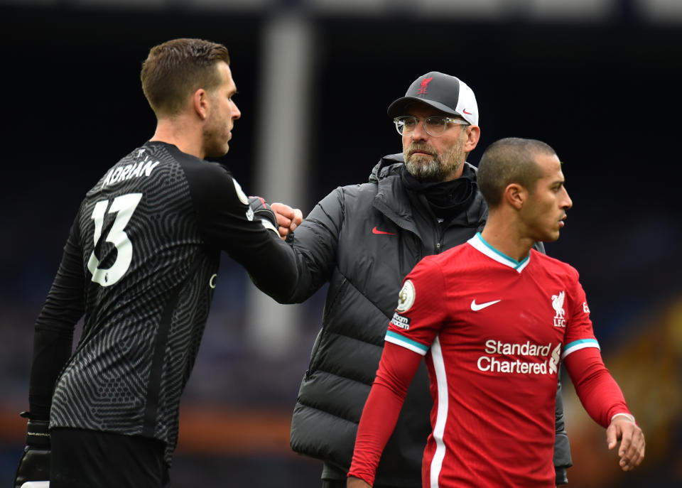 LIVERPOOL, ENGLAND - OCTOBER 17: (THE SUN OUT, THE SUN ON SUNDAY OUT ) Thiago Alcantara of Liverpool with Jurgen Klopp manager of Liverpool with Adrian of Liverpool at the end of the Premier League match between Everton and Liverpool at Goodison Park on October 17, 2020 in Liverpool, England. Sporting stadiums around the UK remain under strict restrictions due to the Coronavirus Pandemic as Government social distancing laws prohibit fans inside venues resulting in games being played behind closed doors. (Photo by Andrew Powell/Liverpool FC via Getty Images)