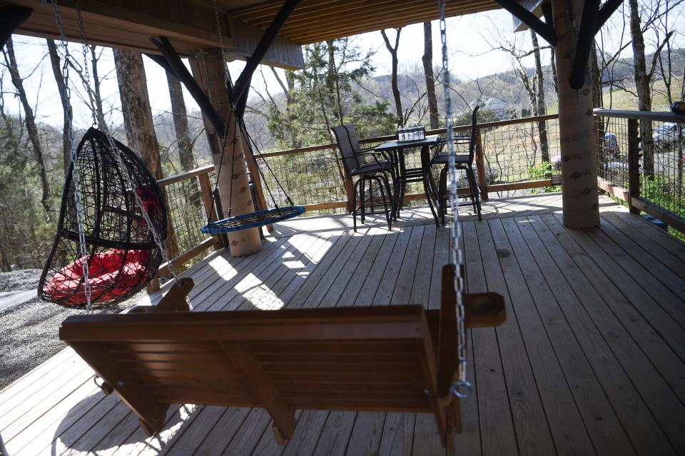 Swings and patio furniture are found under the living space at Sanctuary Treehouse Resort.