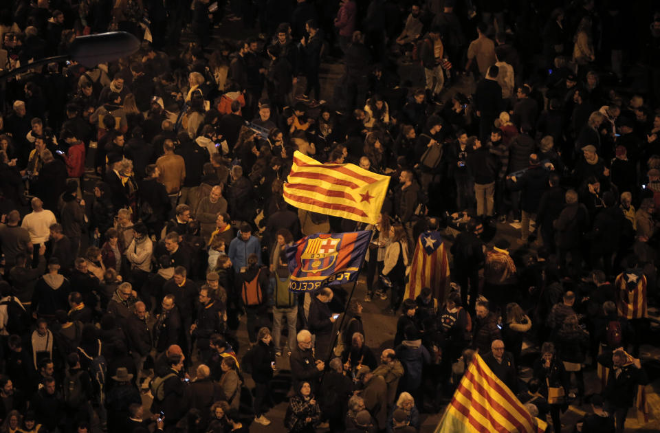 Catalan pro-independence demonstrators and Barcelona supporters gather outside the Camp Nou stadium ahead of a Spanish La Liga soccer match between Barcelona and Real Madrid in Barcelona, Spain, Wednesday, Dec. 18, 2019. Thousands of police and private security personnel were deployed Wednesday in and around Barcelona's Camp Nou stadium to ensure that a protest over Catalonia's separatist movement does not disrupt one of the world's most-watched soccer matches. (AP Photo/Joan Mateu)