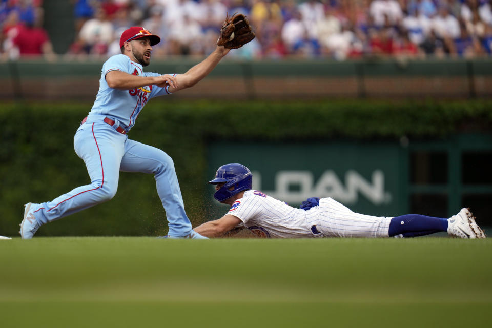 Chicago Cubs' Nico Hoerner, right, slides past St. St. Louis Cardinals shortstop Paul DeJong to steal second base during the first inning of a baseball game, Saturday, July 22, 2023, in Chicago. (AP Photo/Erin Hooley)