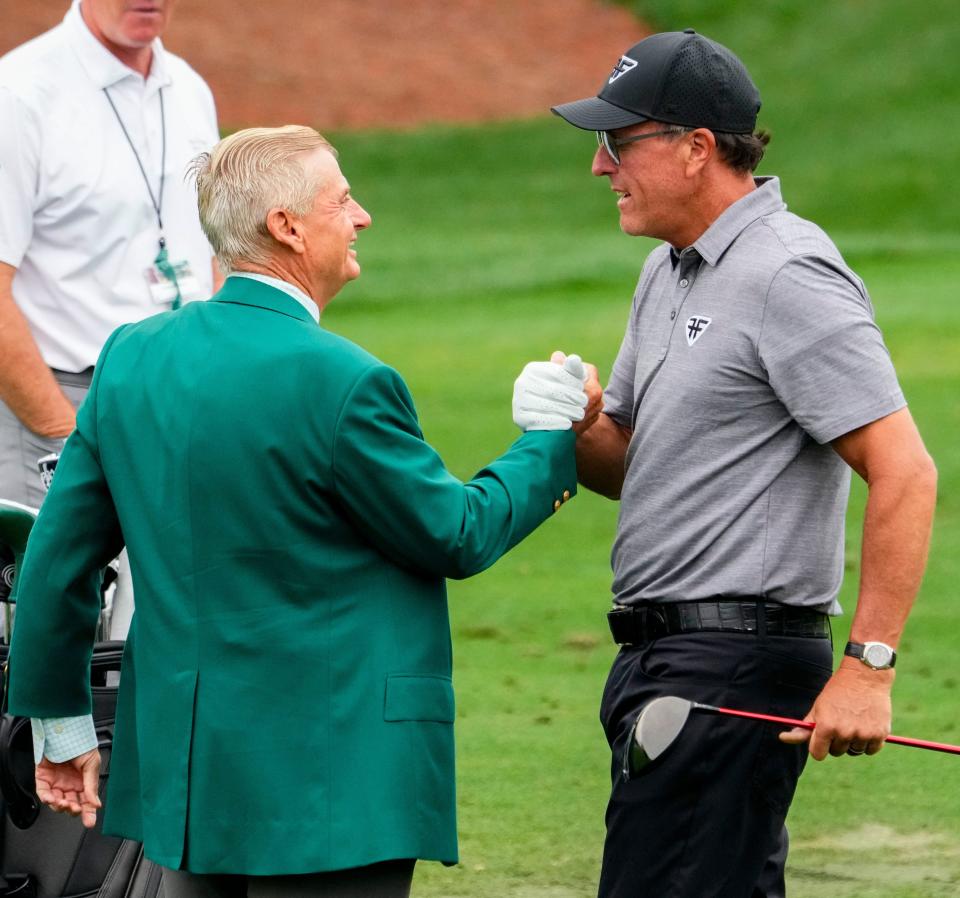 Phil Mickelson (right) greets Augusta National member Jimmy Dunne (left) during a practice round for The Masters in April.