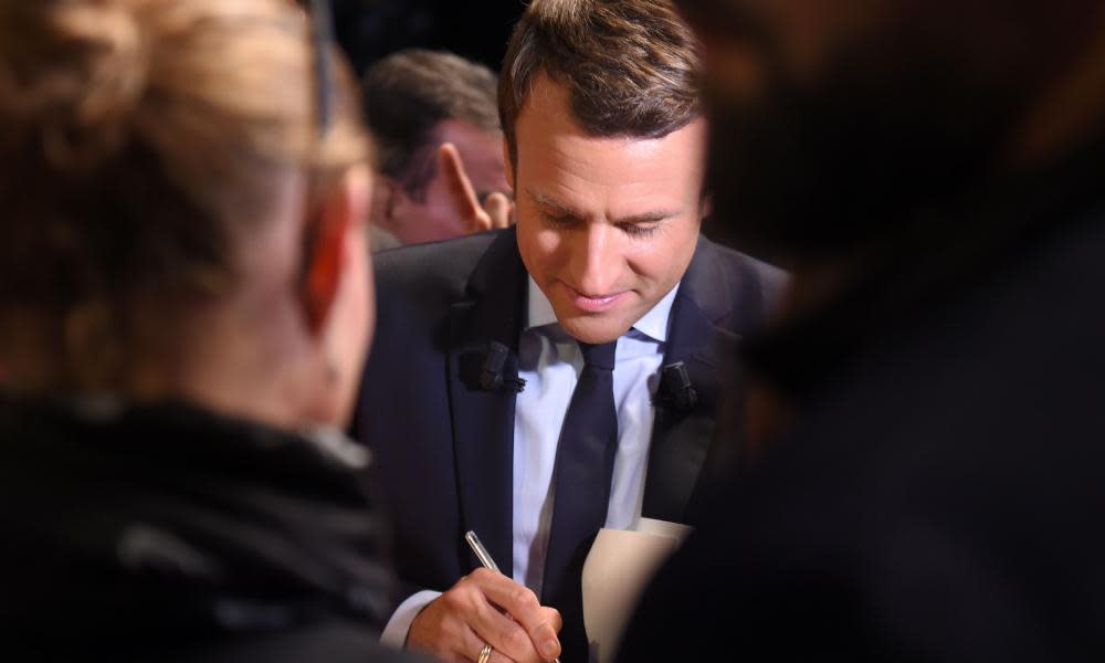 Macron signing autographs