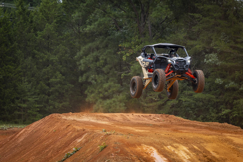 In this photo provided by Can Am Off-Road, Hailie Deegan takes laps in a Can-Am Maverick X3 on the track she carved into the front yard of her first home, in Denver, N.C., on Aug. 30. 2022. Deegan is the only full-time female driver at the NASCAR national level but her future is unclear after Friday night’s Truck Series season finale. (Can Am Off-Road via AP)