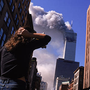 Manhattanites observe the burning World Trade Center towers on September 11, 2001. / Credit: Andrew Lichtenstein/Corbis via Getty Images