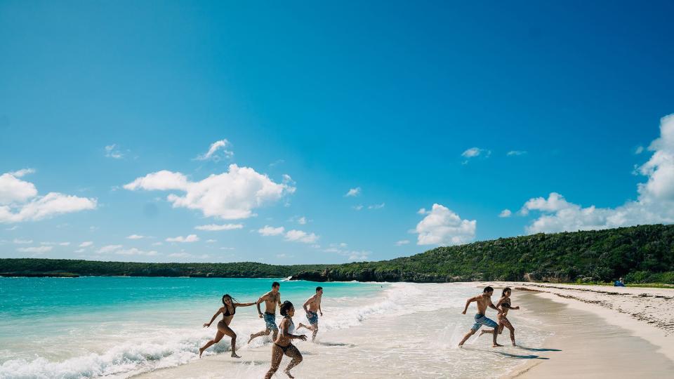 People running out of the water at Caracas Beach, Vieques, Puerto Rico
