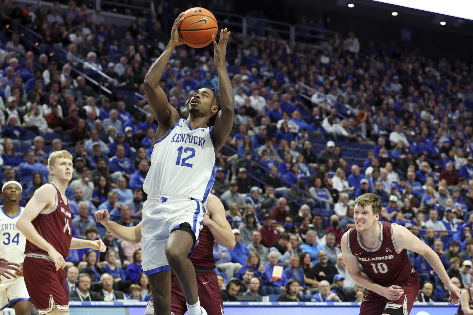 Kentucky's Antonio Reeves (12) shoots as Bellarmine's Sam DeVault (14) and Garrett Tipton (10) watch during the first half of an NCAA college basketball game in Lexington, Ky., Tuesday, Nov. 29, 2022. (AP Photo/James Crisp)