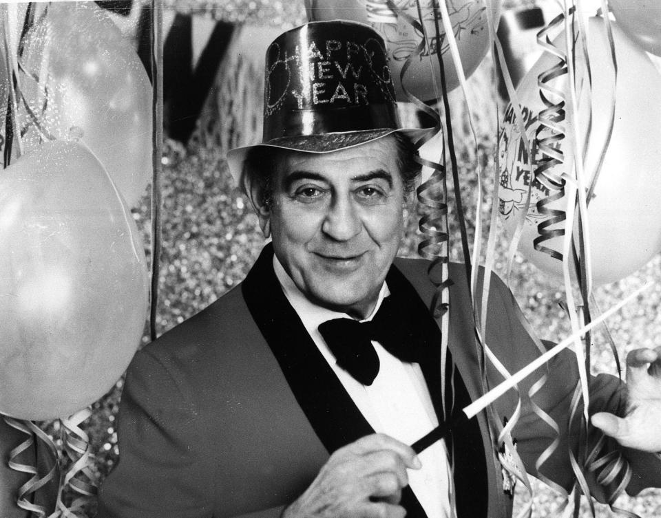 Bandleader Guy Lombardo poses with New Year's decorations in this 1976 file photo. The famed orchestra leader, whose rendition of "Auld Lang Syne" became a holiday mainstay, gave his final televised New Year's performance that year.