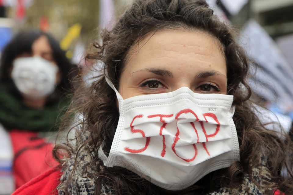 A medical staff wears a mask during a national demonstration Thursday, Nov. 14, 2019 in Paris. Among the demands being made are more staff , pay rises, in particular for those on low salaries, and providing more beds. (AP Photo/Michel Euler)