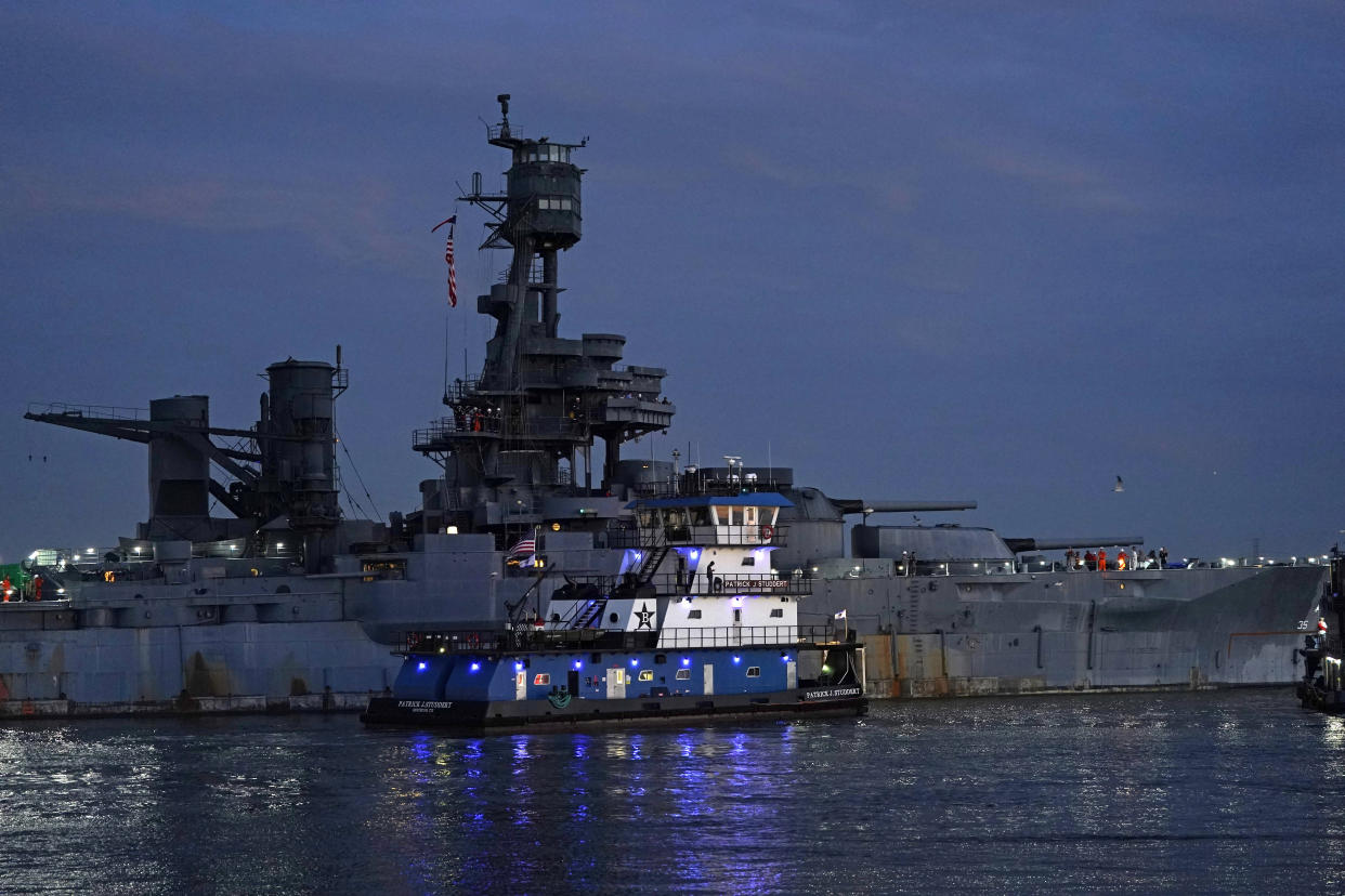 The USS Texas is moved into position to be towed Wednesday, Aug. 31, 2022, in La Porte, Texas. The vessel, which was commissioned in 1914 and served in both World War I and World War II, is being towed down the Houston Ship Channel to a dry dock in Galveston where it will undergo an extensive $35 million repair. (AP Photo/David J. Phillip)