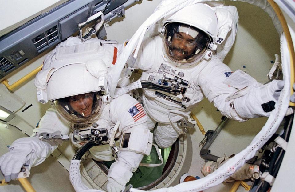 Astronauts Bernard A. Harris Jr., STS-63 payload commander, (top right) and C. Michael Foale, mission specialist, are ready to egress airlock for an extravehicular activity (EVA) on Feb. 9, 1995.