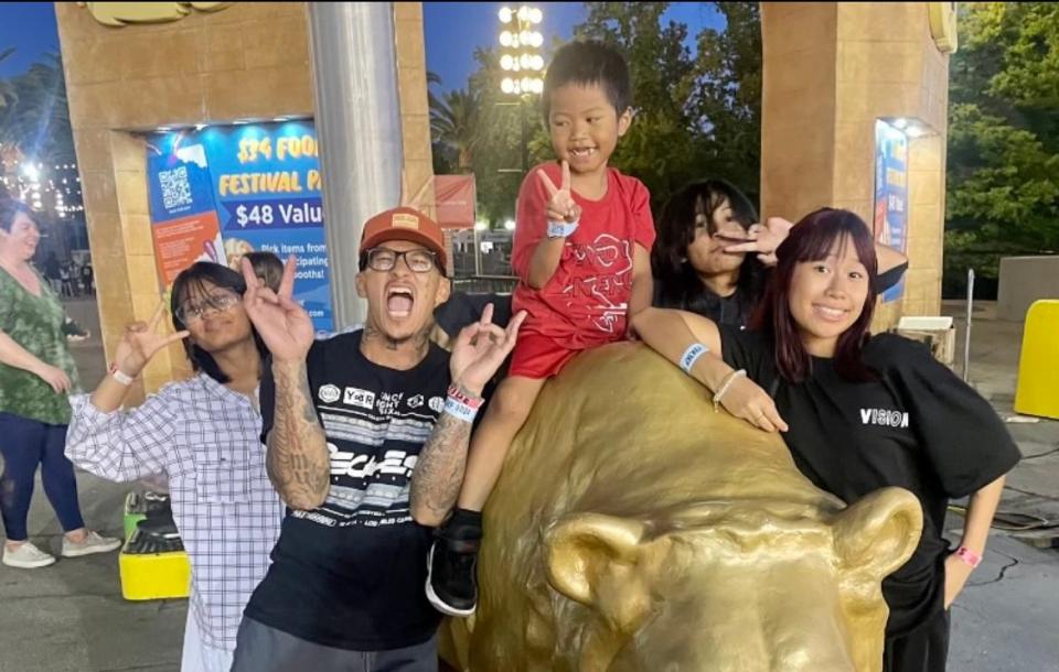 Thy Tuy is photographed with his girlfriend's three children and younger sister during a family trip to the California State Fair on Monday, July 24, 2023.