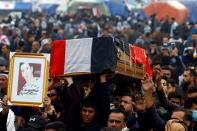 Mourners carry the coffin during the funeral of a demonstrator who was killed at an anti-government protest overnight in Najaf