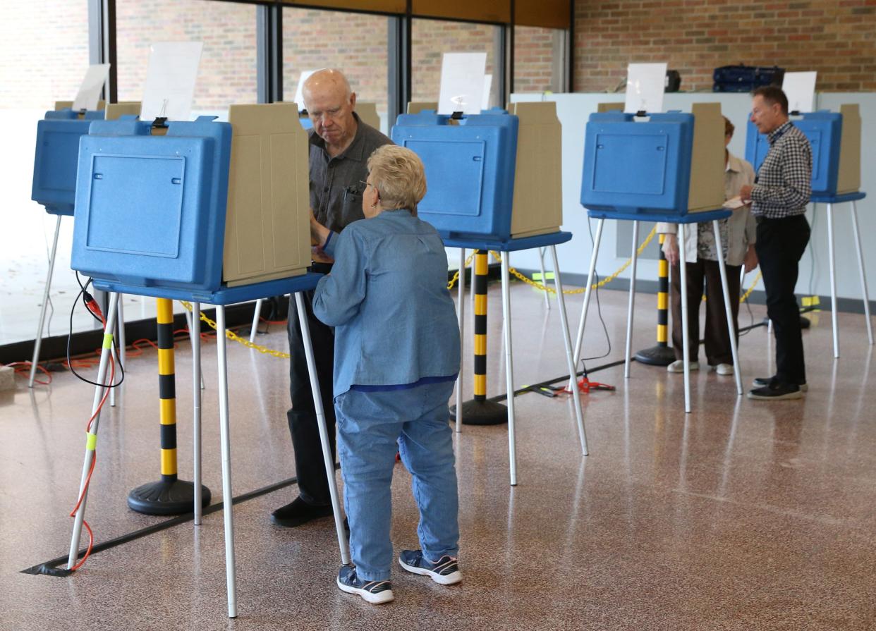 Poll workers help to put voters at the voting machines Friday, Oct. 27, 2023, in the lobby of the County-City Building in South Bend. Early voting is now taking place in St. Joseph County.