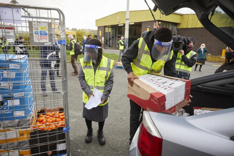 Marcus Rashford and his mother help FareShare Greater Manchester distribute food (PA)