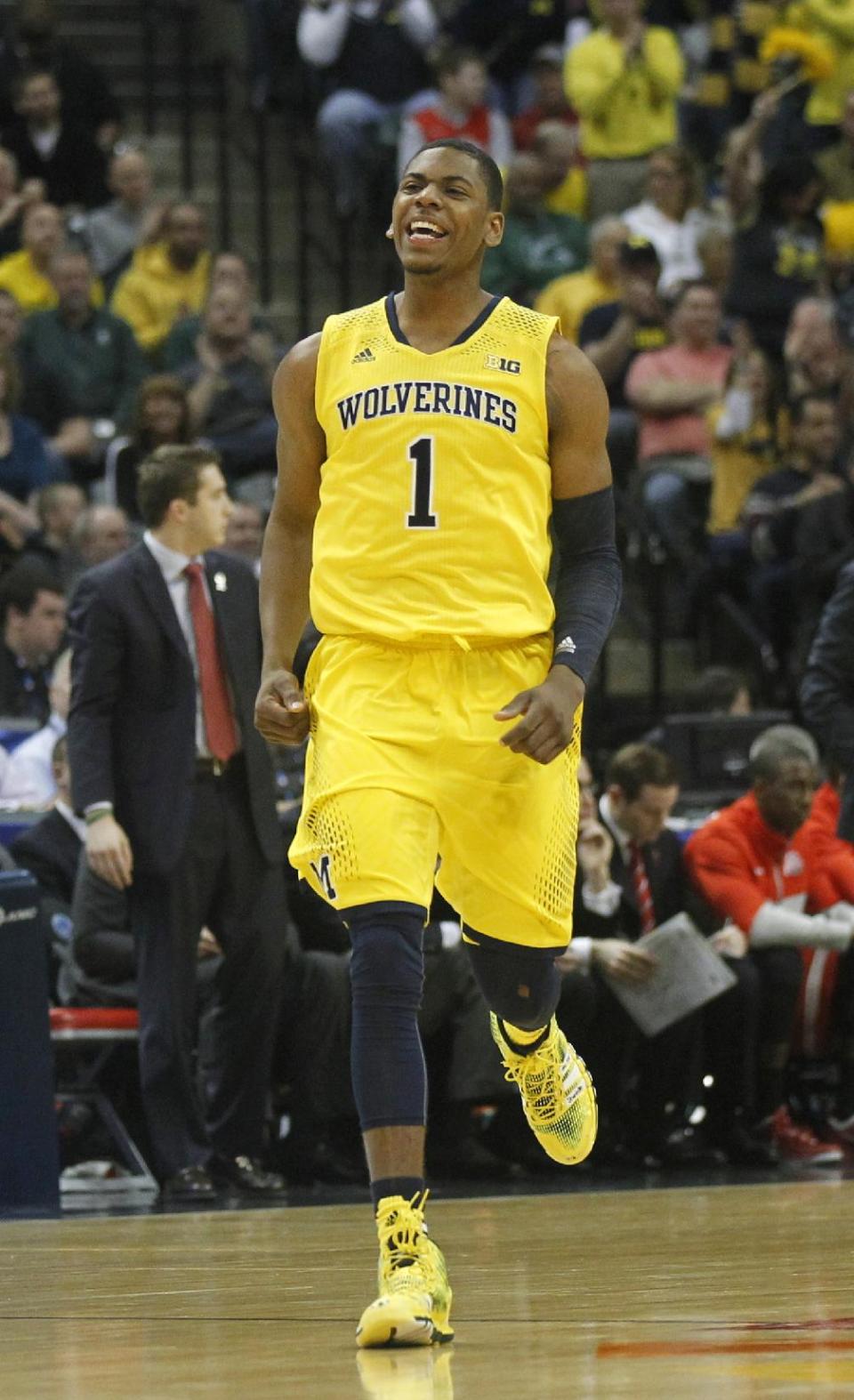 Michigan forward Glenn Robinson III celebrates after sinking a three pointer in the first half of an NCAA college basketball game against Ohio State in the semifinals of the Big Ten Conference tournament Saturday, March 15, 2014, in Indianapolis. (AP Photo/Kiichiro Sato)