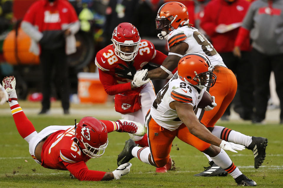 KANSAS CITY, MISSOURI - JANUARY 17: Running back Nick Chubb #24 of the Cleveland Browns is tackled by defensive end Michael Danna #51 of the Kansas City Chiefs during the third quarter of the AFC Divisional Playoff game  at Arrowhead Stadium on January 17, 2021 in Kansas City, Missouri. (Photo by David Eulitt/Getty Images)