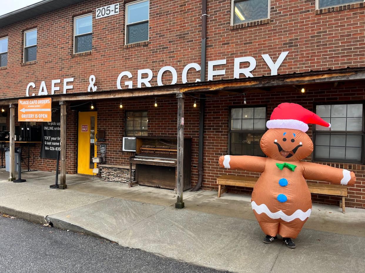 A gingerbread mascot poses outside of the Swamp Rabbit Cafe and Grocery.