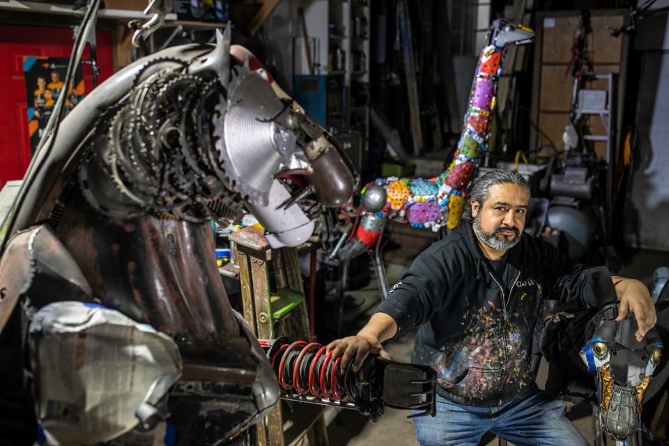 Elton Monroy Duran, 45, is a conceptual artist living in southwest Detroit and works out of his garage sculpting metal into what he calls the Alebrijes of the Motor City, on Thursday, Feb. 8, 2024. Alebrijes are brightly colored Mexican folk art sculptures of fantastical, mythical creatures and Duran’s are made from auto parts that shaped the auto industry. Duran is making a connection between the Mexican workers that contributed to the car industry in the 1920s and the growth of the auto industry, like the Model T.