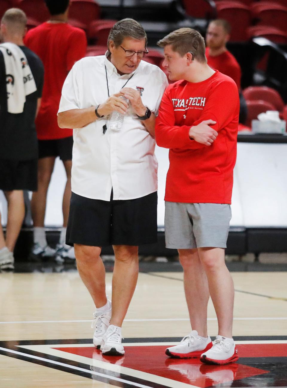 Head Coach Mark Adams talks to his son, Luke, during Texas Tech’s first official practice, Sept. 26, 2022, at the United Supermarkets Arena in Lubbock. Luke is the Director of Player Development.