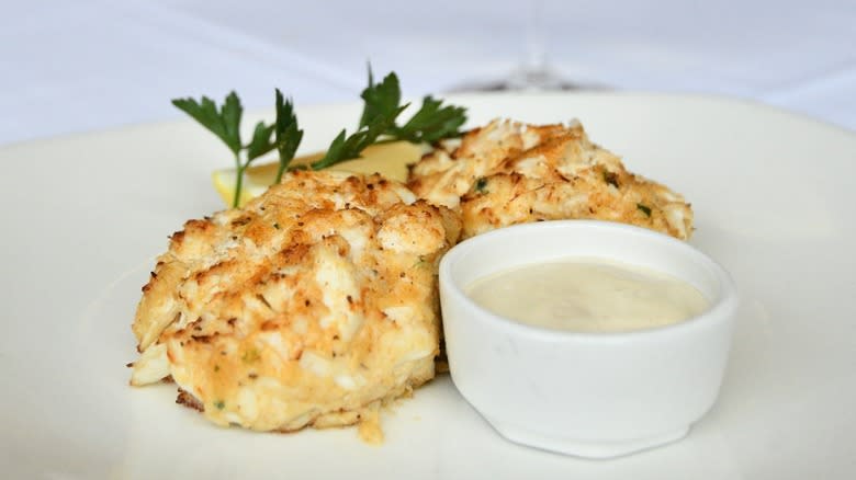 Plated crab cakes with sauce