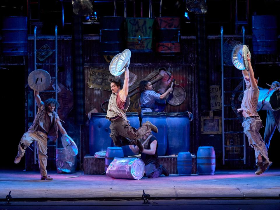 Performers bang on trash can lids to create rhythm and moves in the hit show “Stomp.”