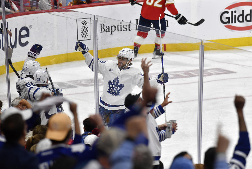 Toronto Maple Leafs players surround defenseman Erik Gustafsson after he scored a goal against the Florida Panthers during the second period of Game 3 of an NHL hockey Stanley Cup second-round playoff series, Sunday, May 7, 2023, in Sunrise, Fla. (AP Photo/Michael Laughlin)