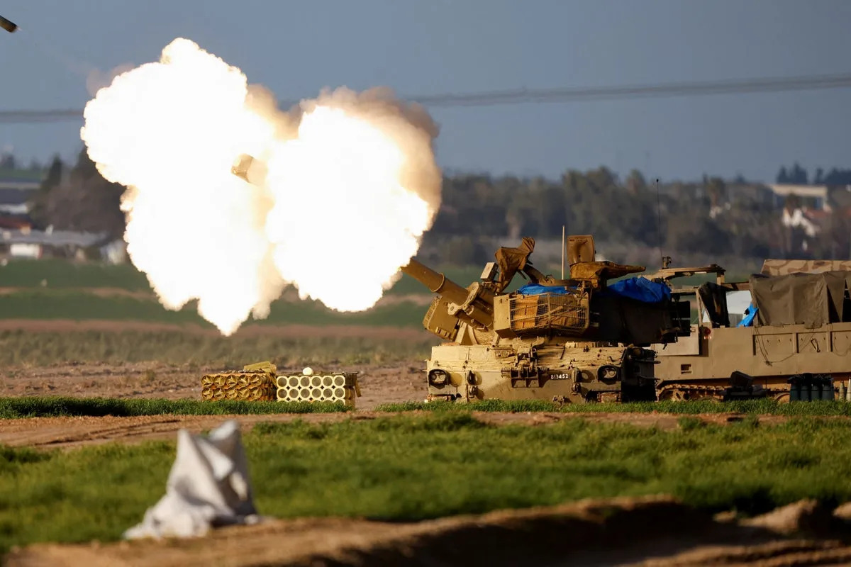 An Israeli mobile artillery unit fires towards Gaza (Reuters)