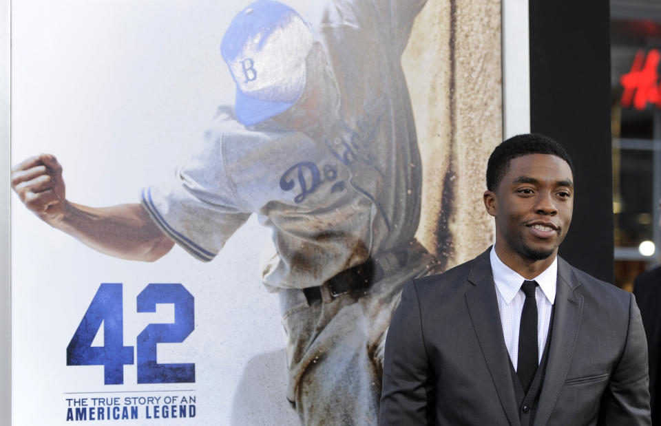 FILE - In this Tuesday, April 9, 2013 file photo, Chadwick Boseman, who plays baseball legend Jackie Robinson in "42," poses at the Los Angeles premiere of the film at the TCL Chinese Theater in Los Angeles. Actor Chadwick Boseman, who played Black icons Jackie Robinson and James Brown before finding fame as the regal Black Panther in the Marvel cinematic universe, has died of cancer. His representative says Boseman died Friday, Aug. 28, 2020 in Los Angeles after a four-year battle with colon cancer. He was 43. (Photo by Chris Pizzello/Invision/AP, File)