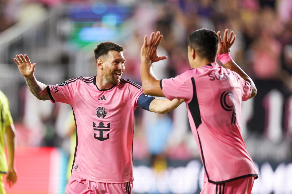 Lionel Messi celebrates with Luis Suarez after scoring a goal against the Nashville SC.