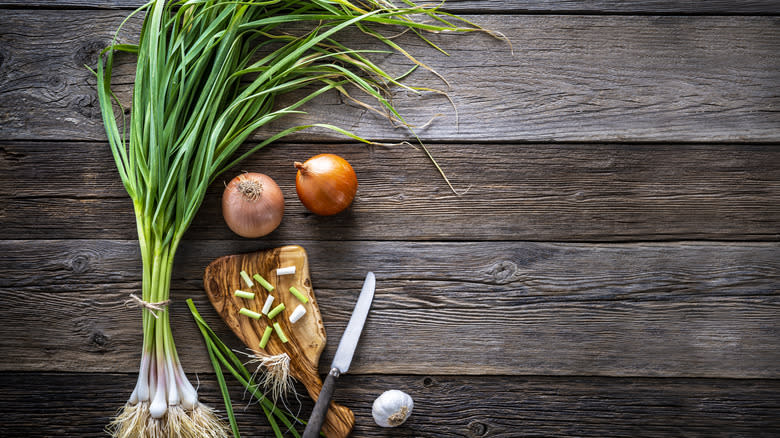 green garlic on wood table